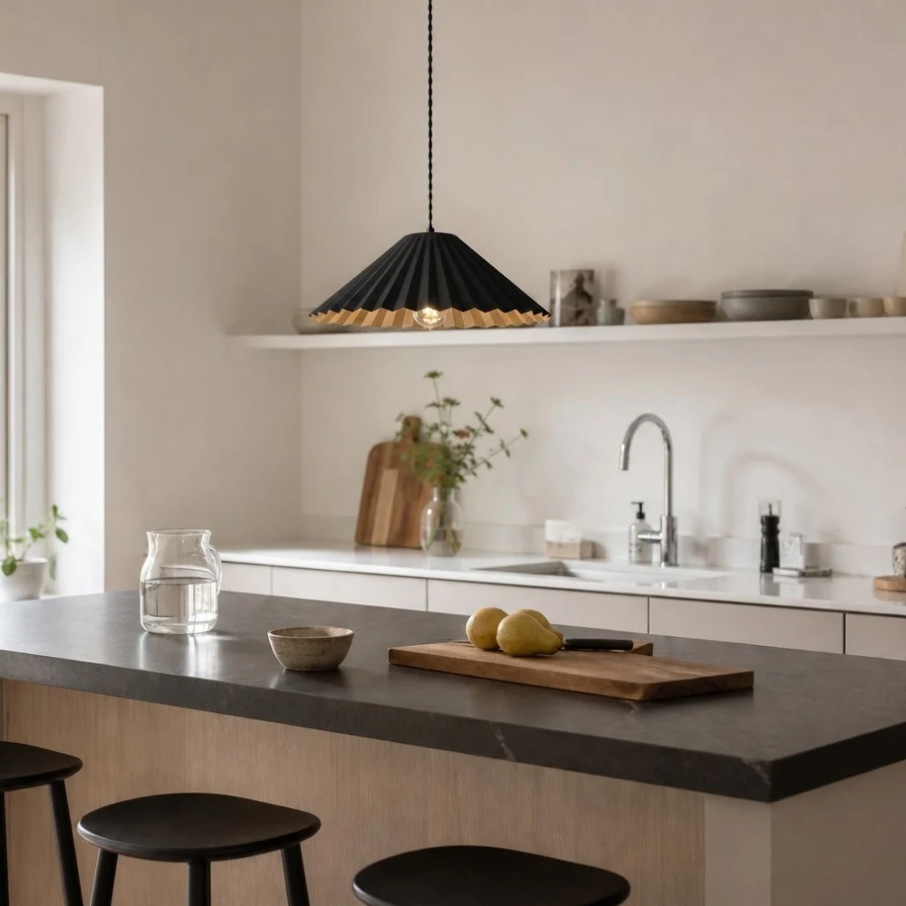 Black metal dome pendant lamp above a kitchen island