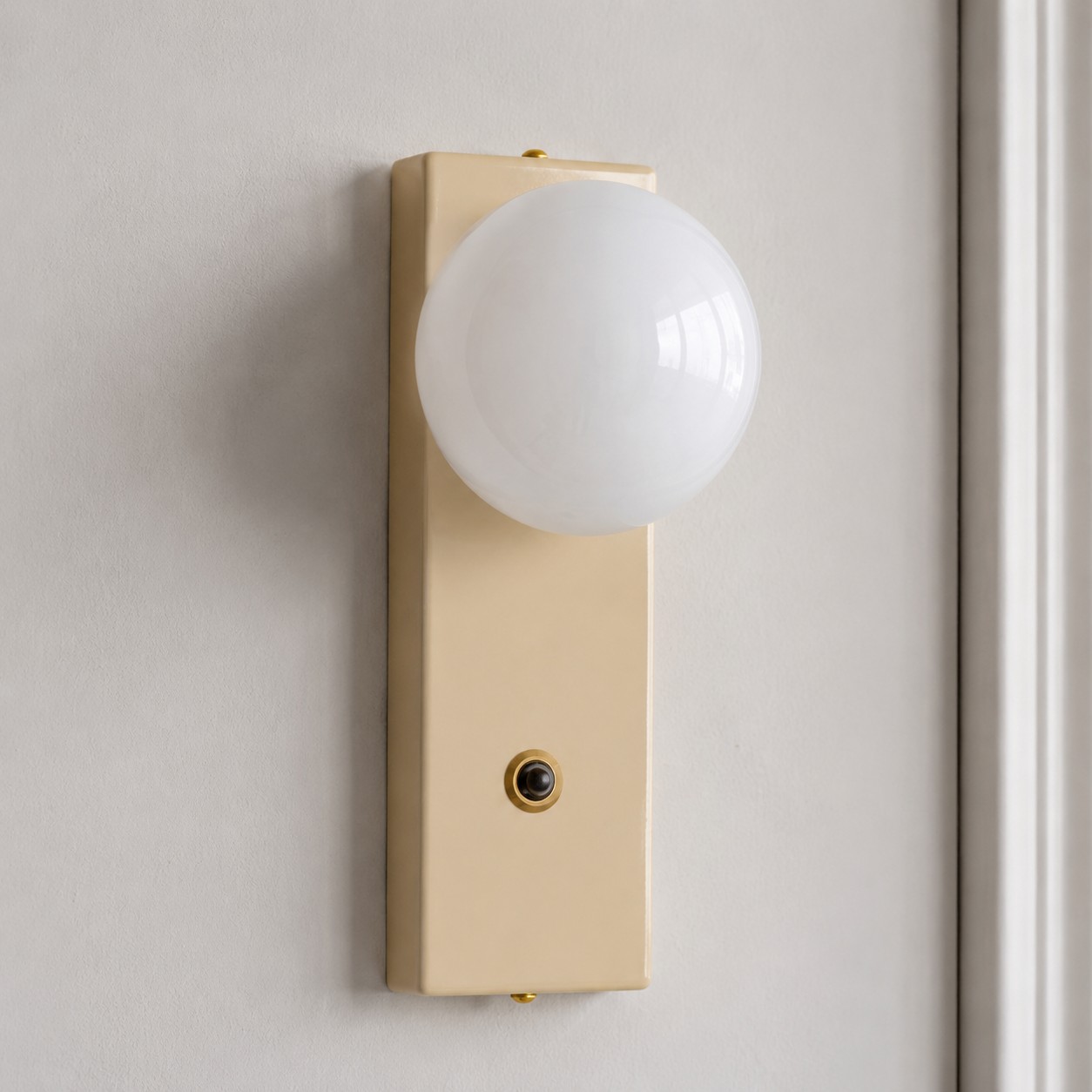 Cream wall sconce with opal glass globe and toggle switch