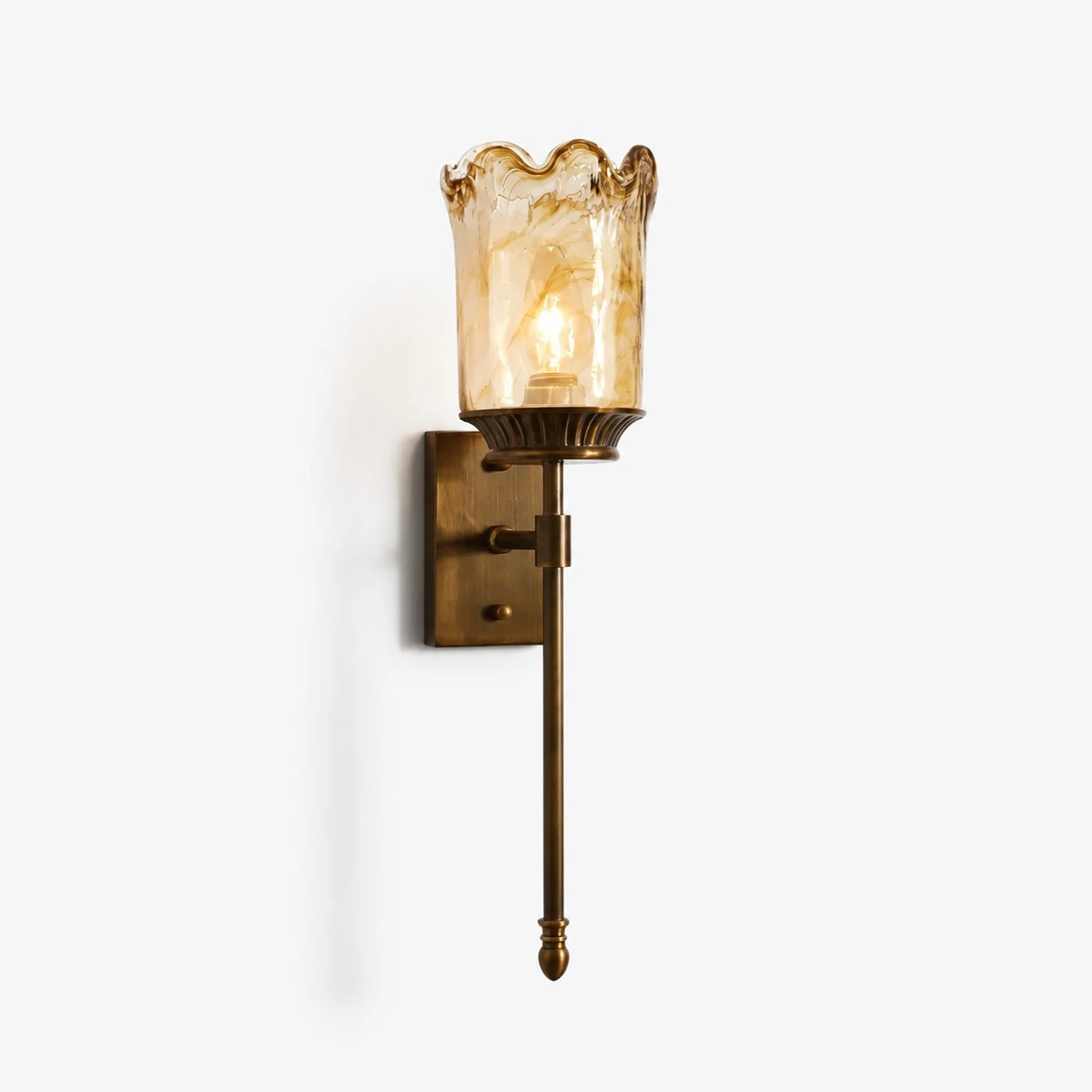 Brass amber glass wall sconce on clean background