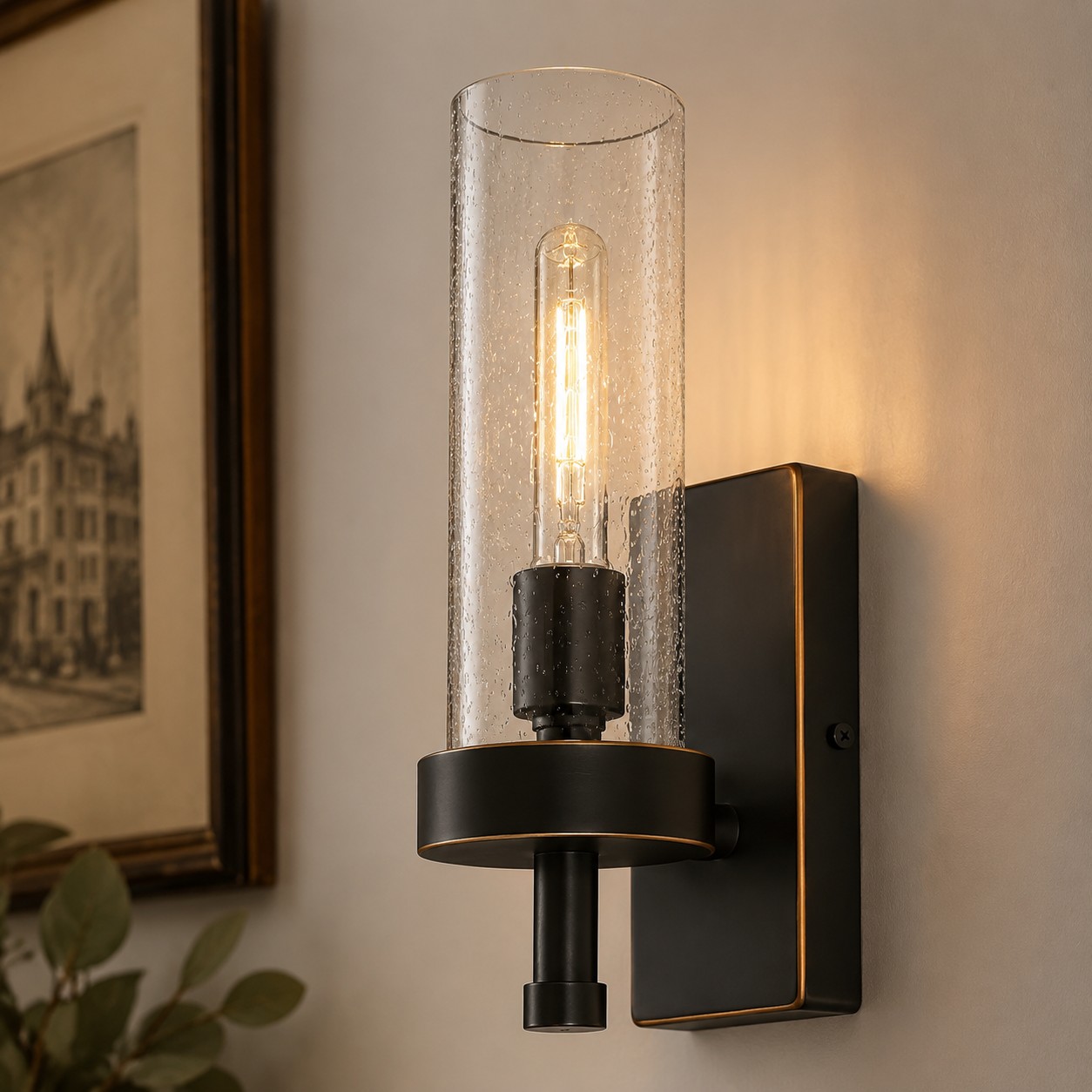 Lit wall sconce beside framed wall art