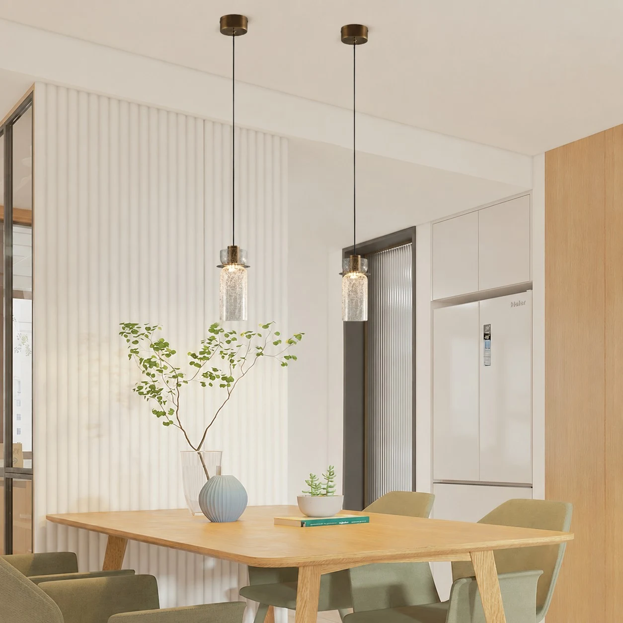 Pair of brass glass pendant lights installed above a kitchen dining table