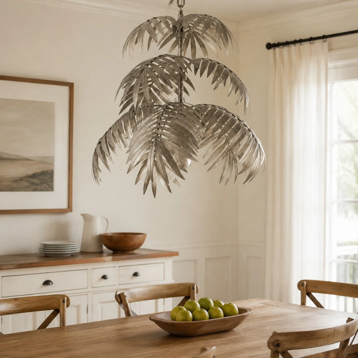 Tiered silver palm leaf chandelier in a dining room