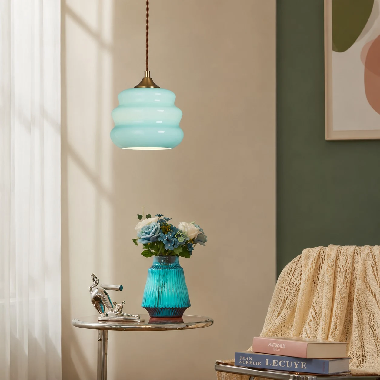 Pendant light styled beside books and flowers