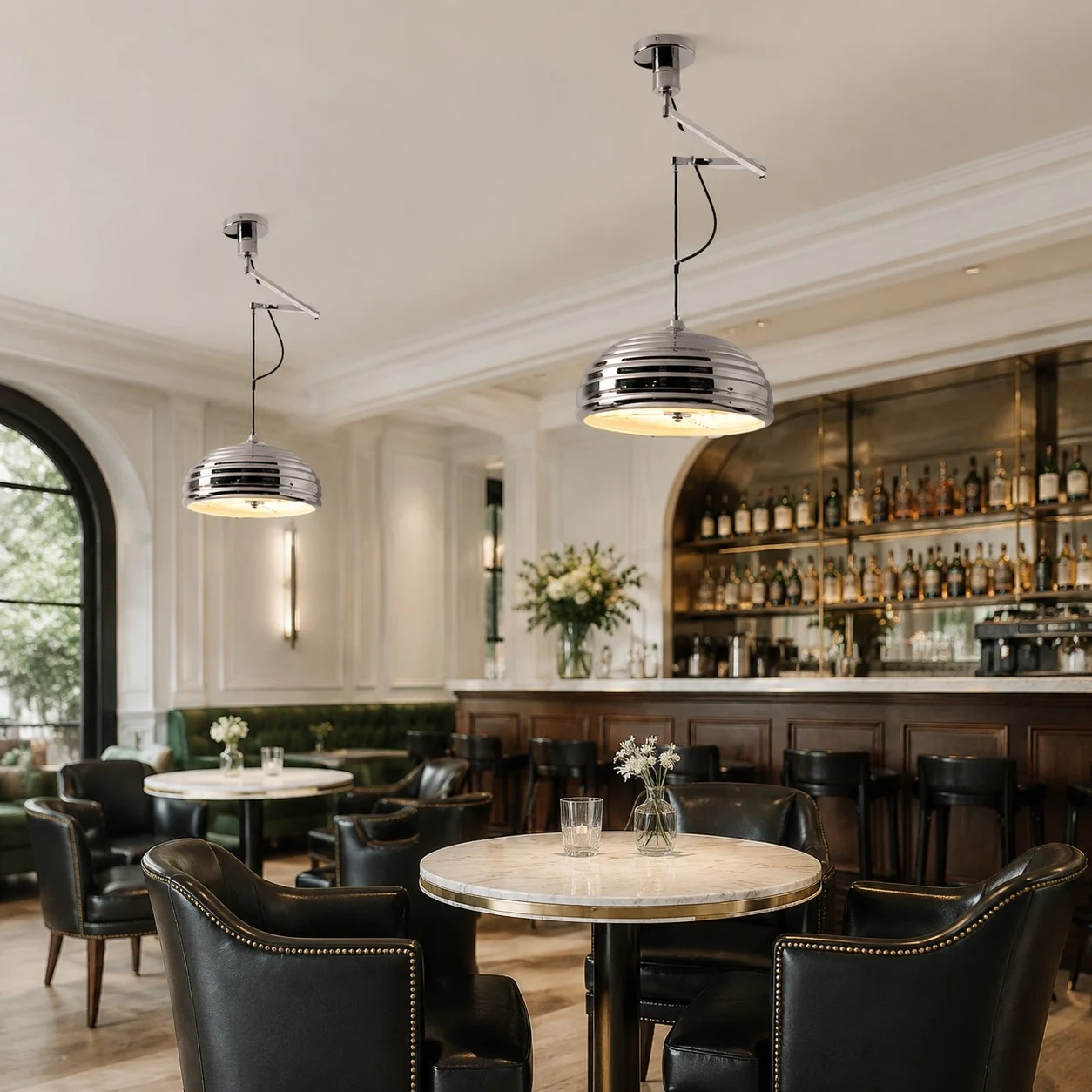 Chrome pendant lights above a restaurant dining table