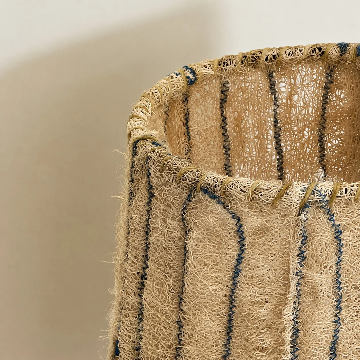 Black woven fiber table lamp on console