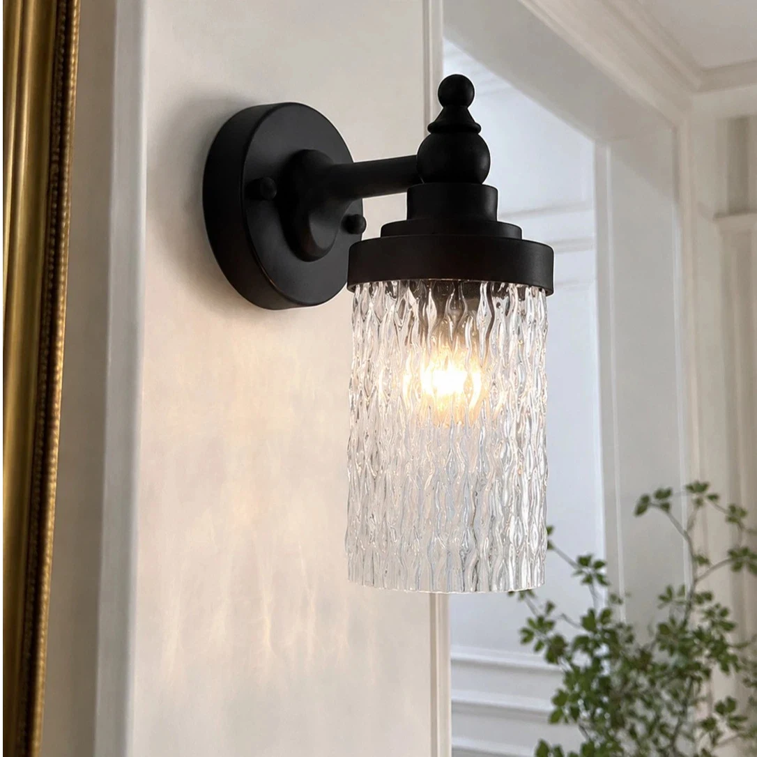 Averra ribbed glass outdoor wall sconce installed beside a covered porch wall