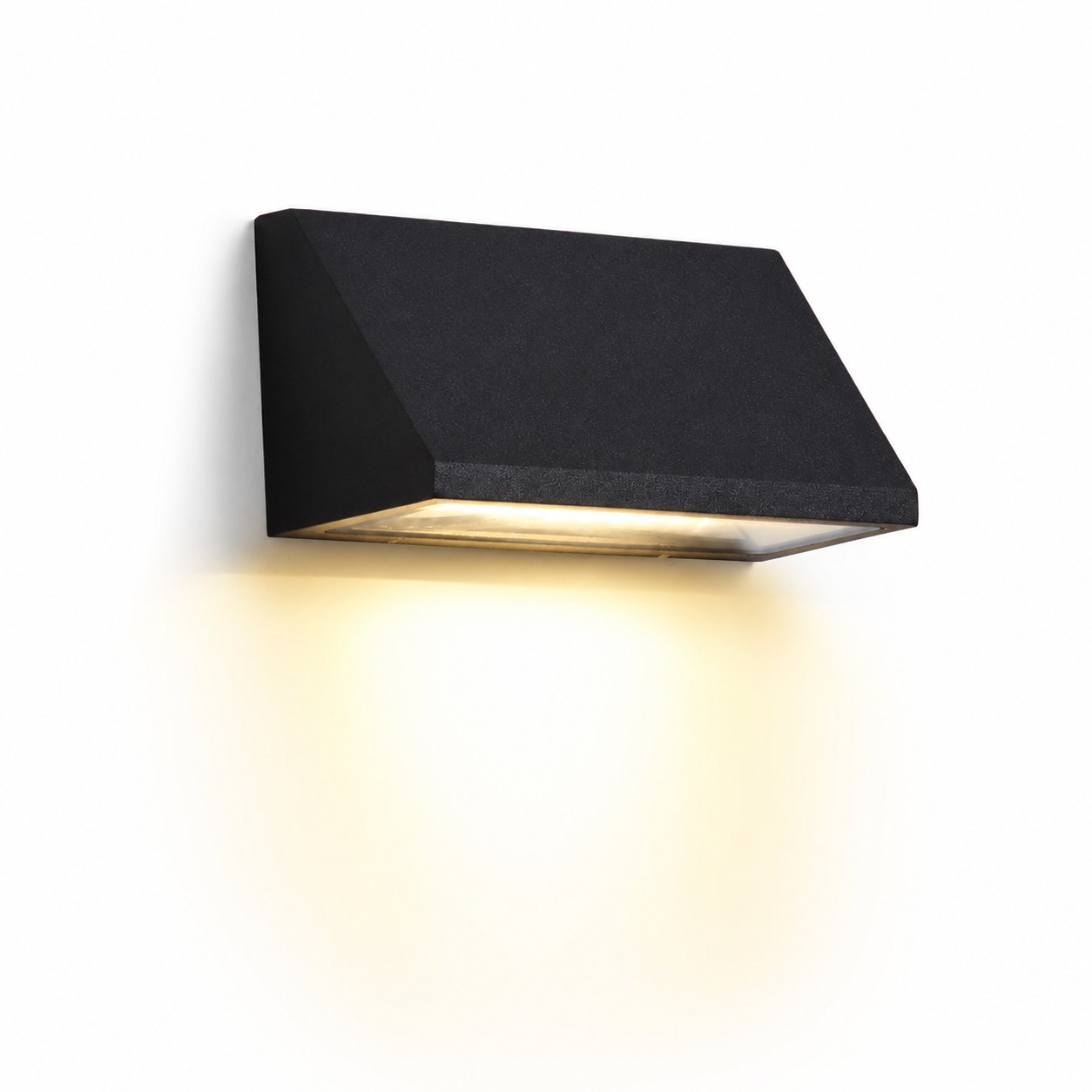 Black wall light glowing on an exterior wall at night