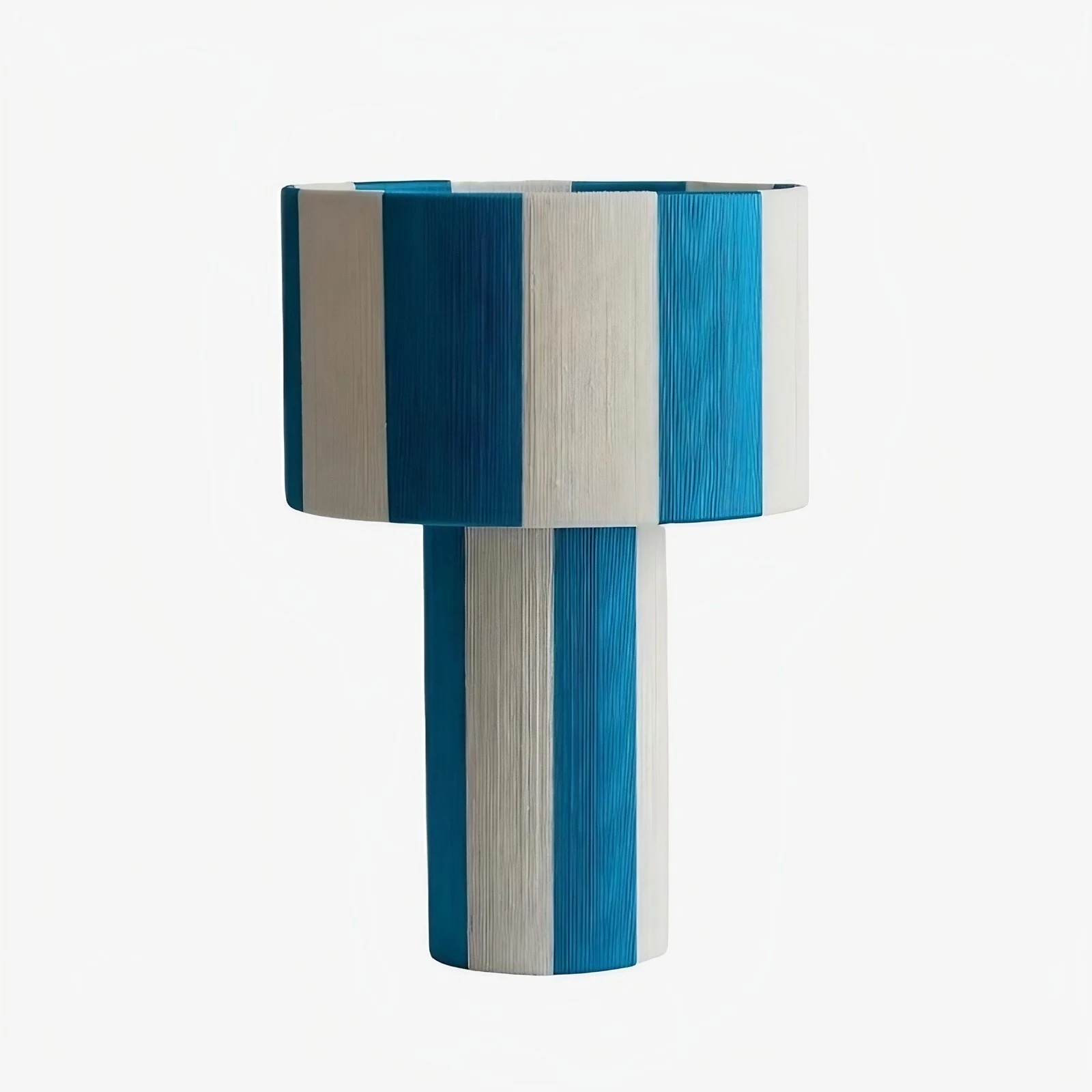 Blue and white striped woven shade table lamp on a white background