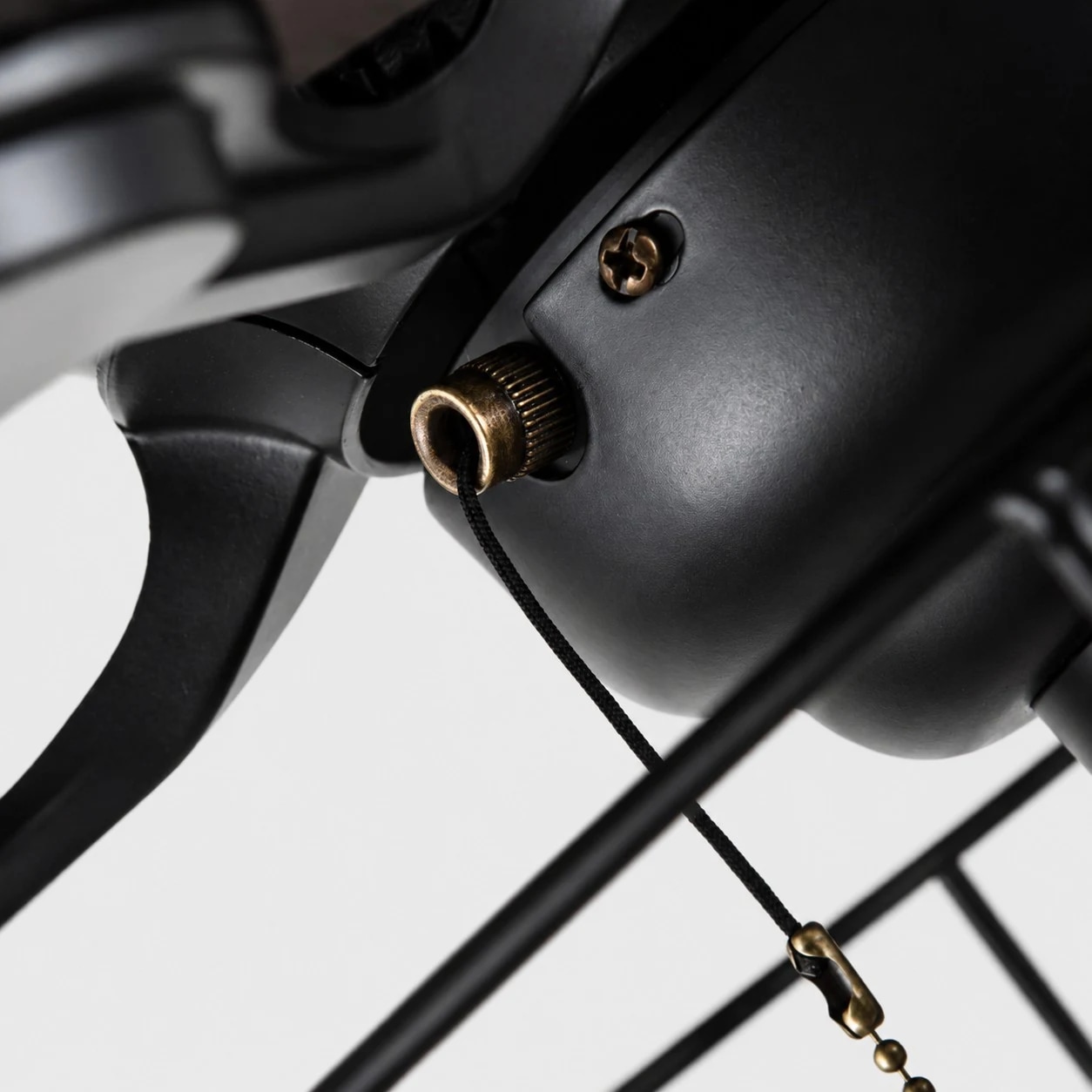 Close view of black ceiling fan motor and pull chain detail
