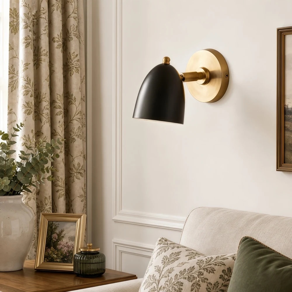 Black and gold wall sconce in a styled room
