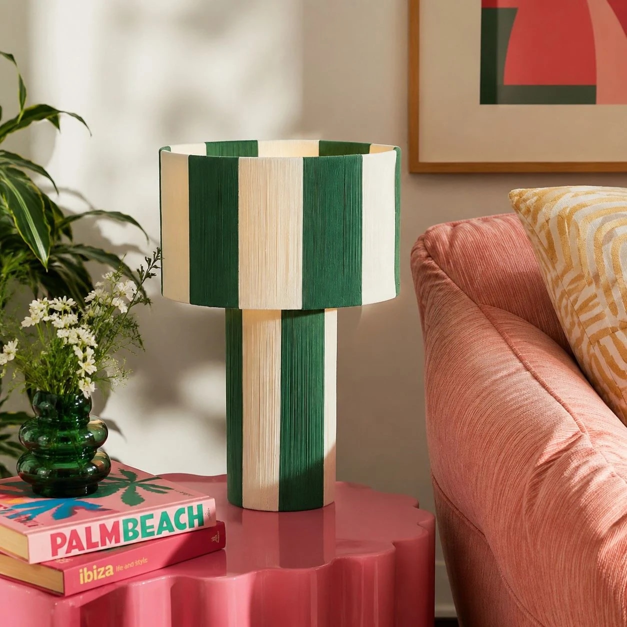 Green striped woven table lamp styled on a pink side table