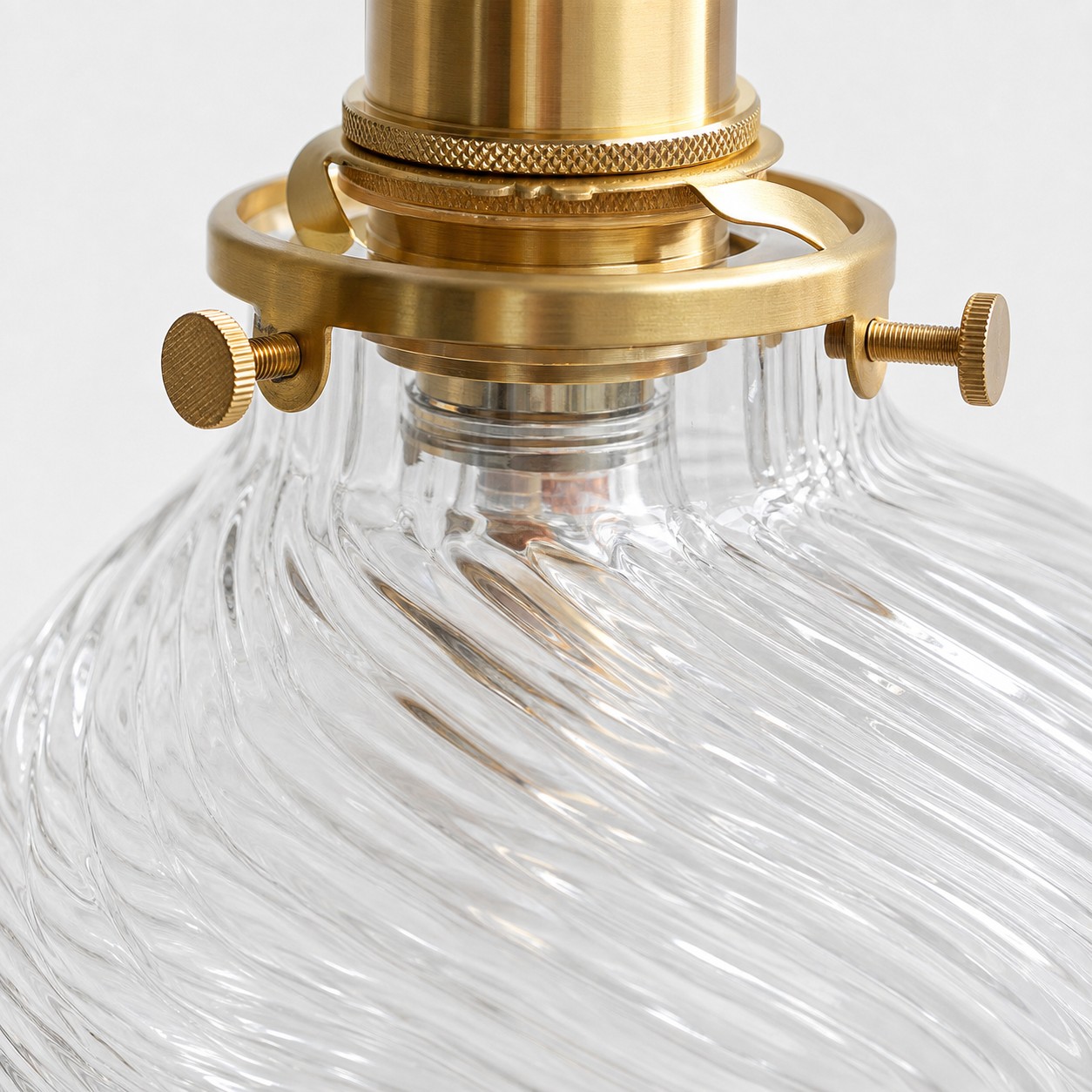 Close view of clear ribbed glass and brass connection