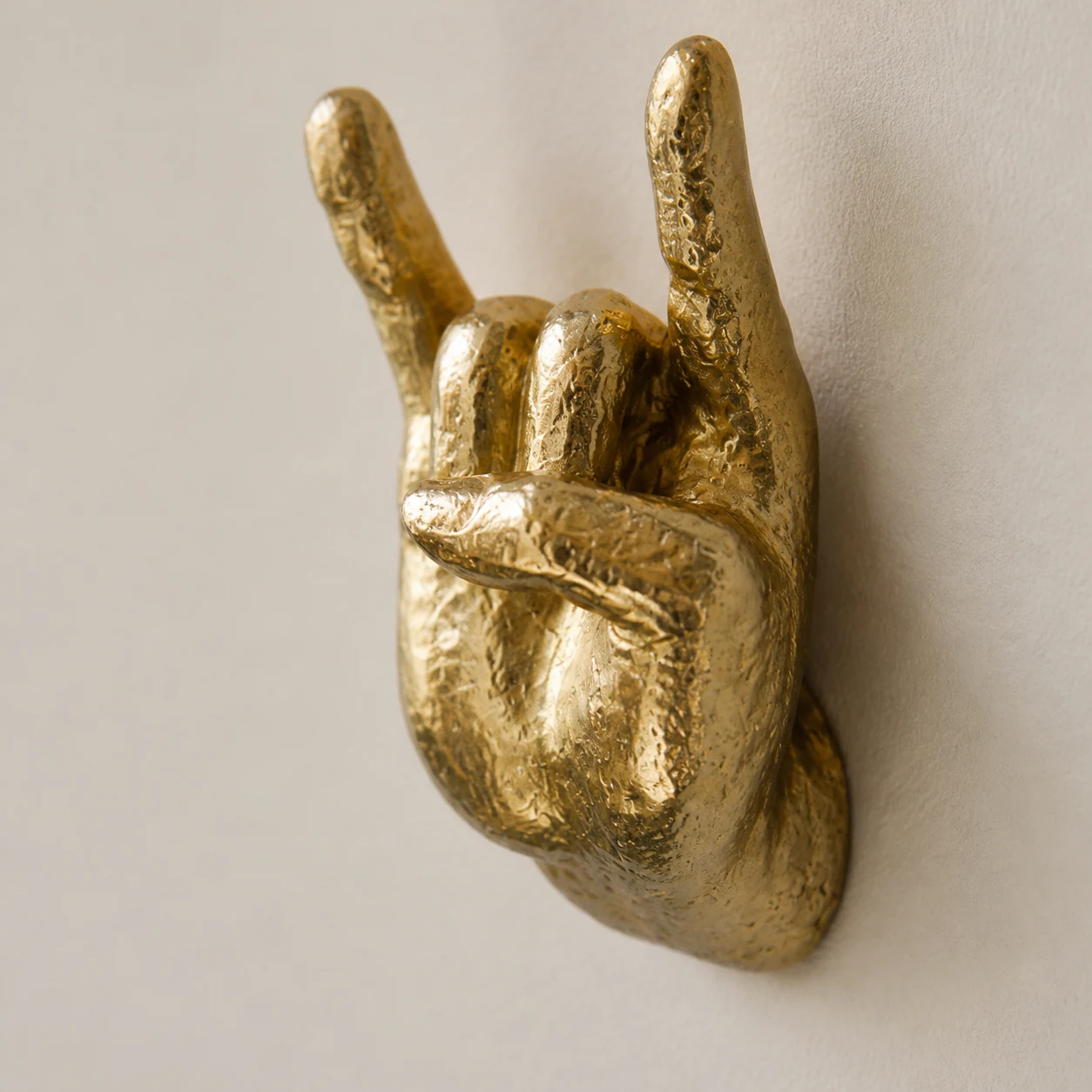 Close-up of the gold textured finish on the rock on wall hand hook