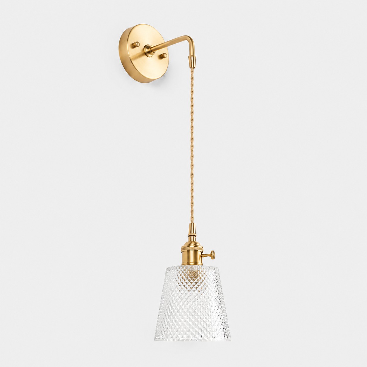 Clear faceted glass wall light with brass arm, AW shade 12 cm high and 13 cm diameter