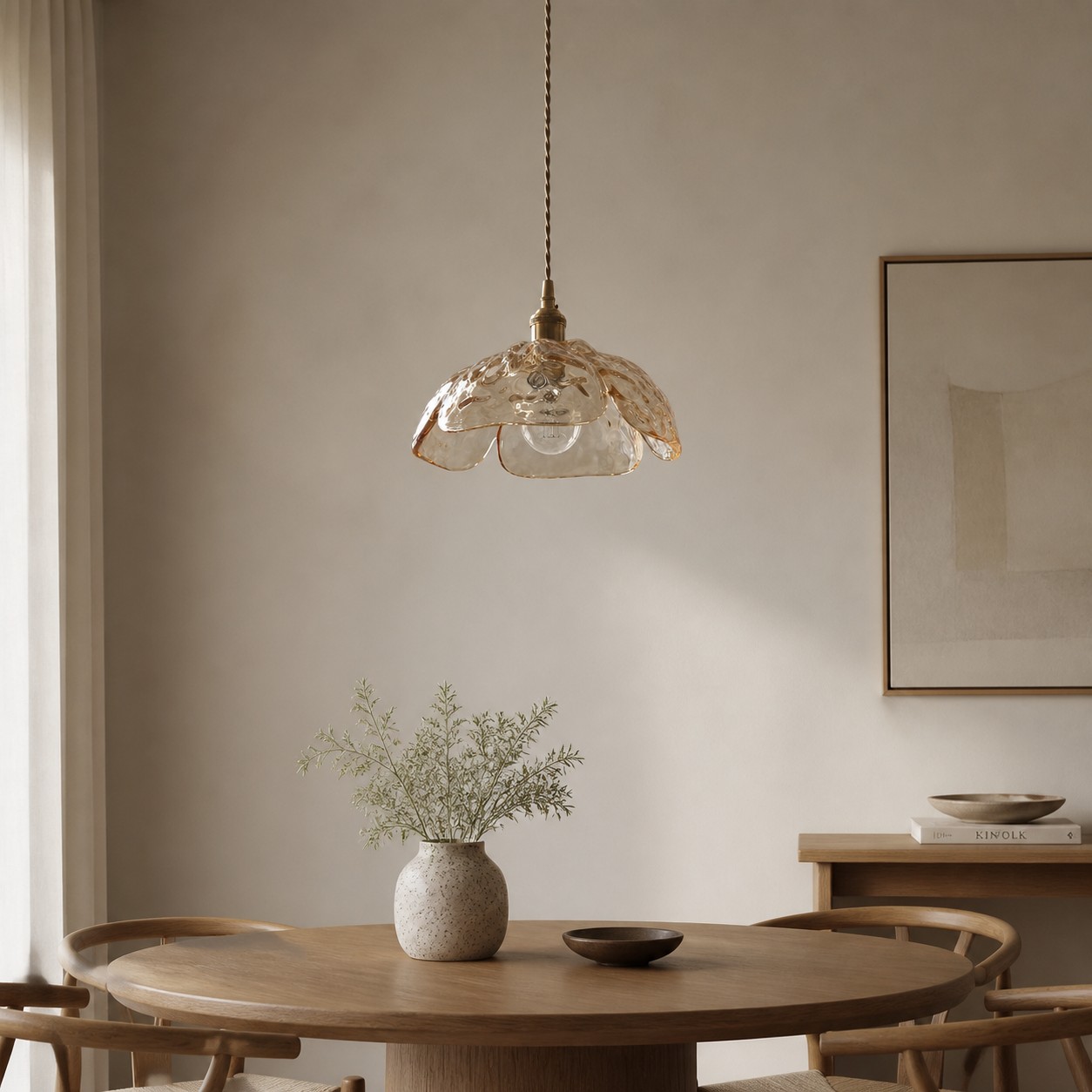 Clear walnut-accent pendant in a calm dining space
