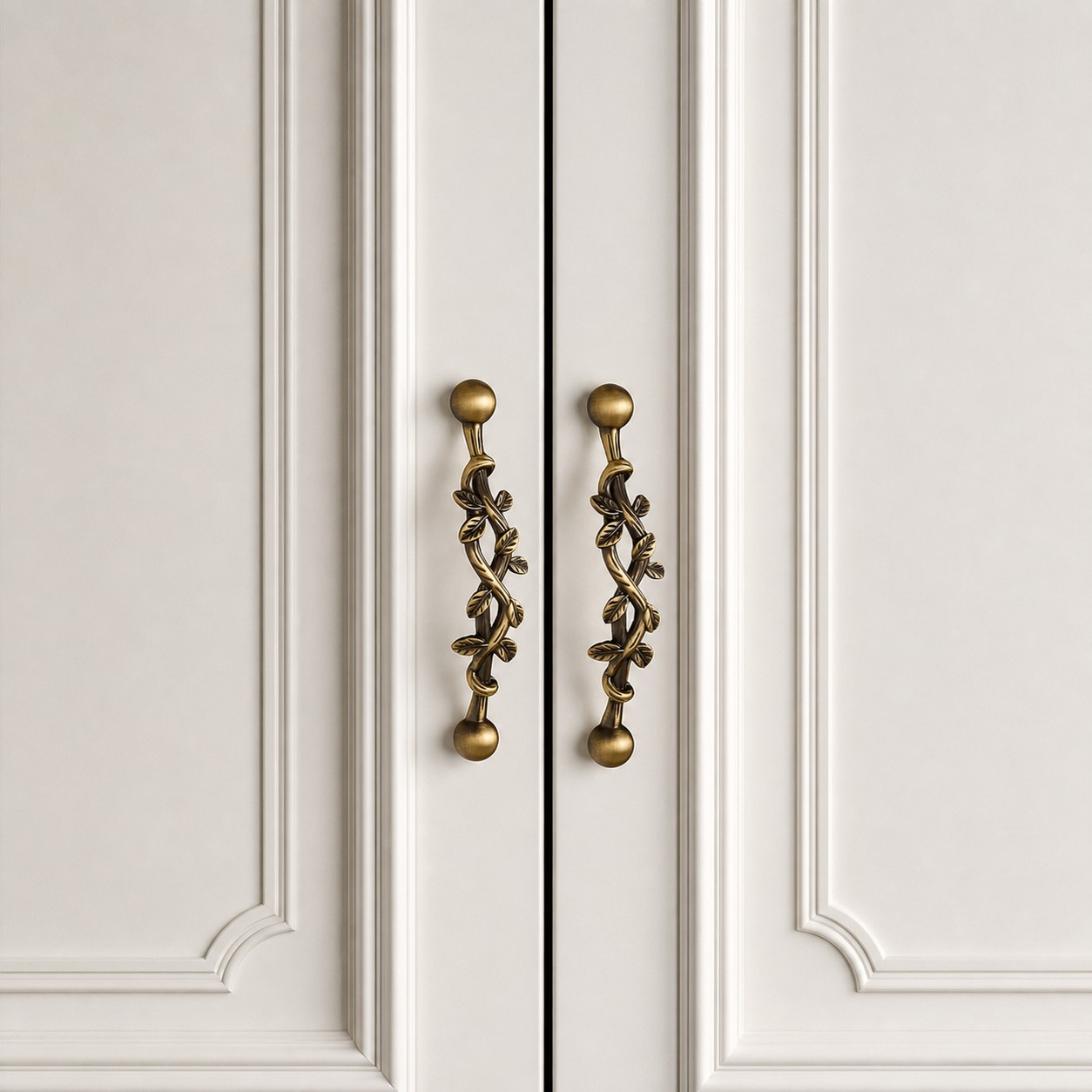 Pair of leaf brass cabinet pulls installed on double doors