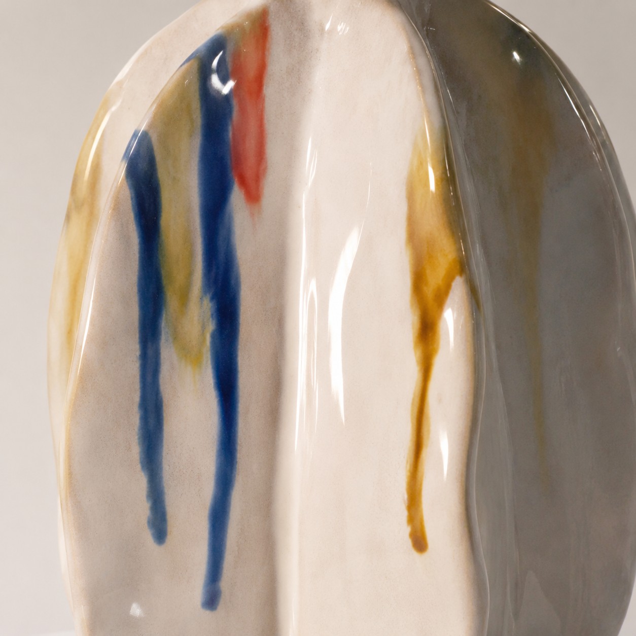 Close view of blue and ochre ceramic glaze strokes